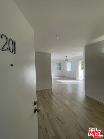a view of a room with window and wooden floor