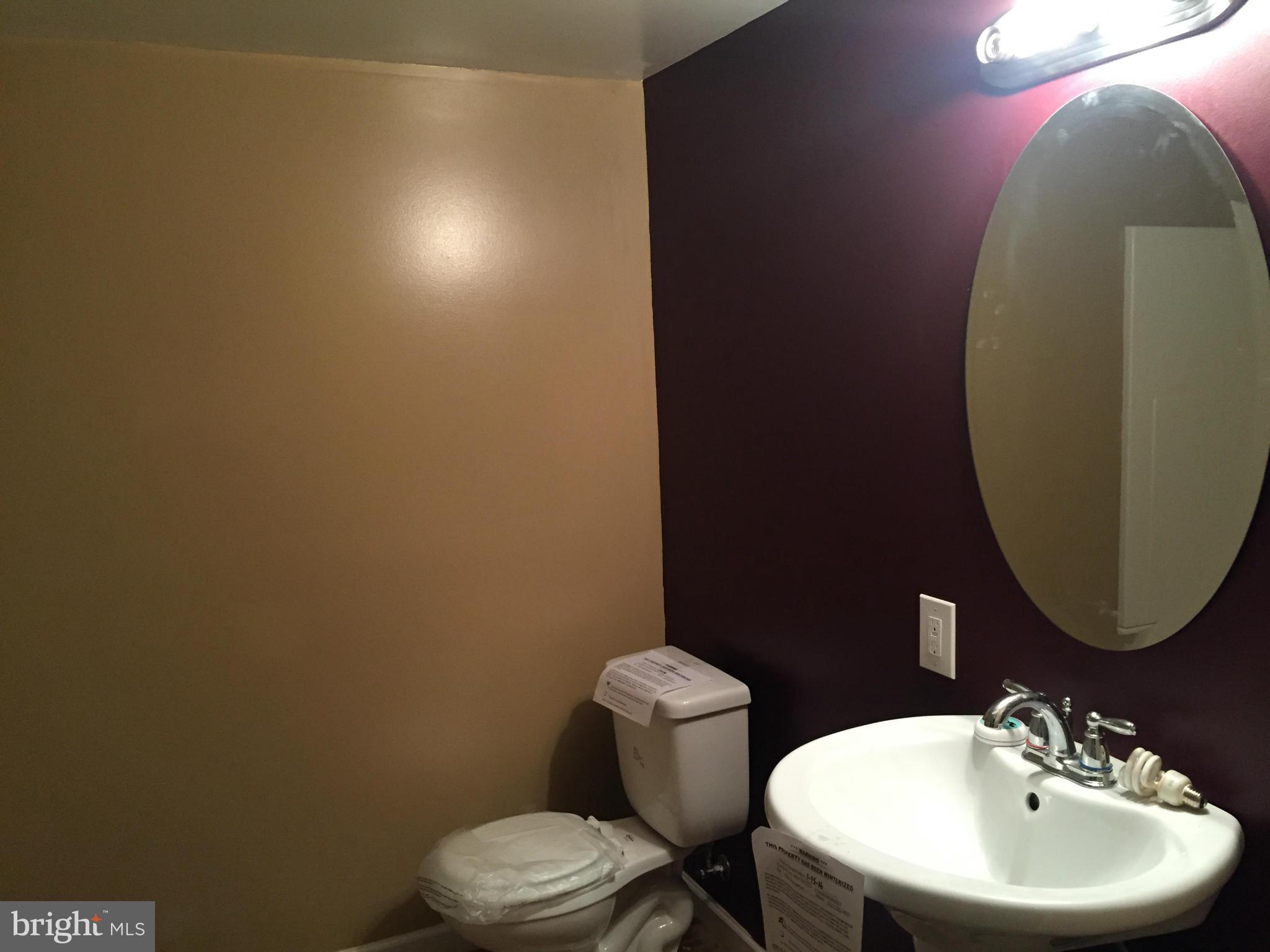 7700 Edgewood Church Road Frederick, MD 21702 - Photo 17 of 24 a bathroom with a toilet sink and mirror