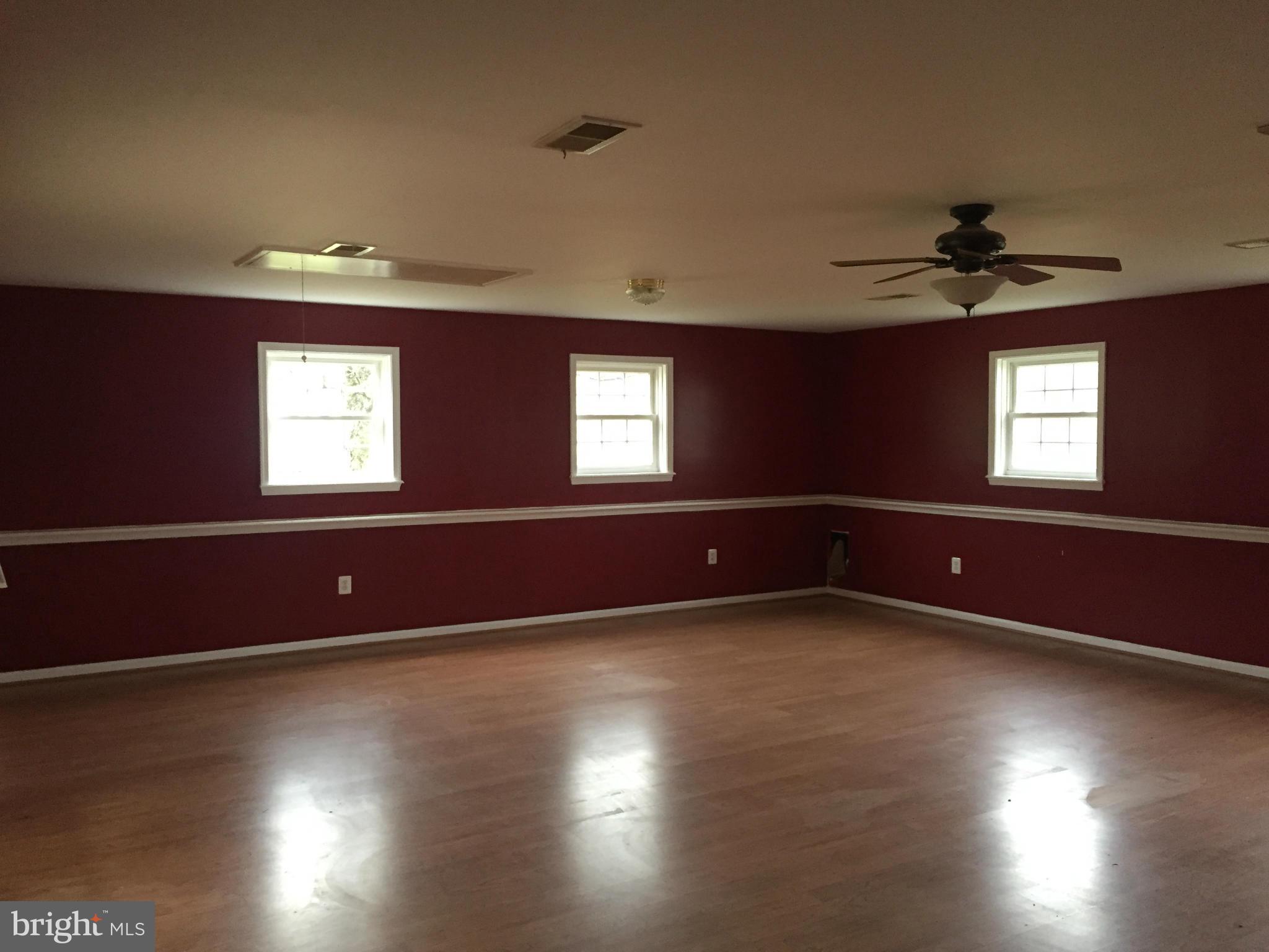 7700 Edgewood Church Road Frederick, MD 21702 - Photo 5 of 24 an empty room with wooden floor and windows