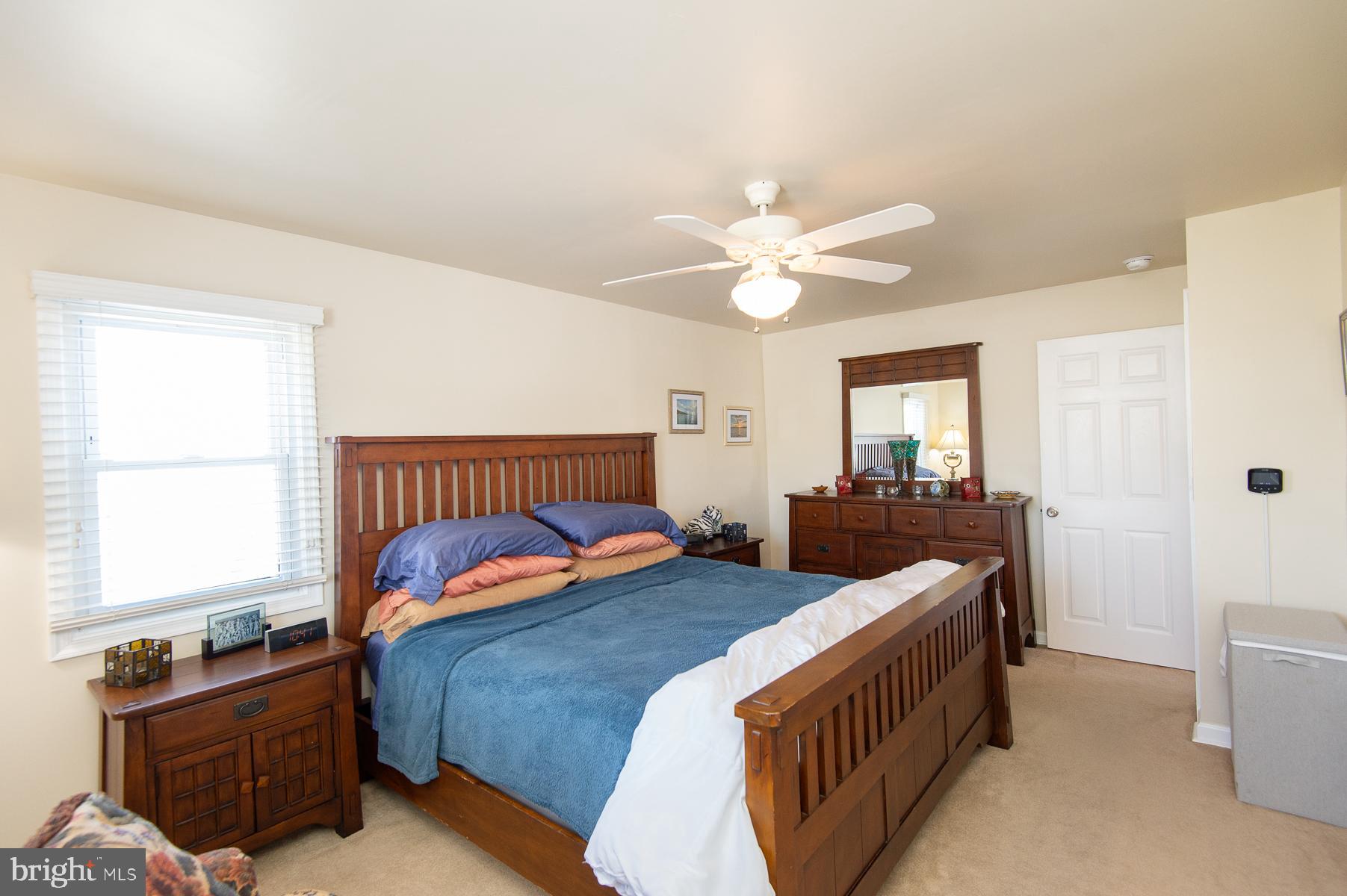 5558 Bowen Road Cambridge, MD 21613 - Photo 15 of 33 a bedroom with a bed and a chandelier