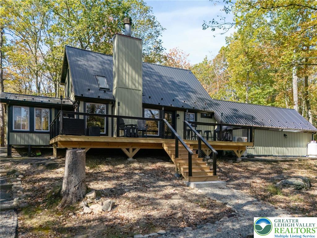 809 Boulder Court North Hawley, PA 18428 - Photo 1 of 43 a view of a house with wooden deck front of house