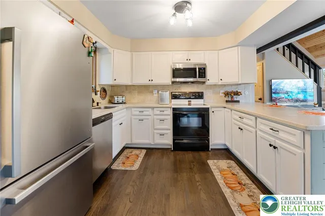 a dining room with furniture a large window and a rug