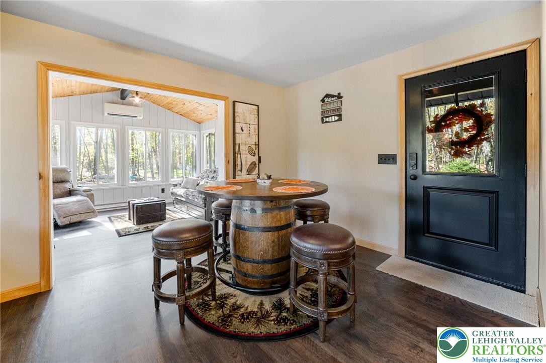 809 Boulder Court North Hawley, PA 18428 - Photo 13 of 43 a dining room with furniture a large window and a rug