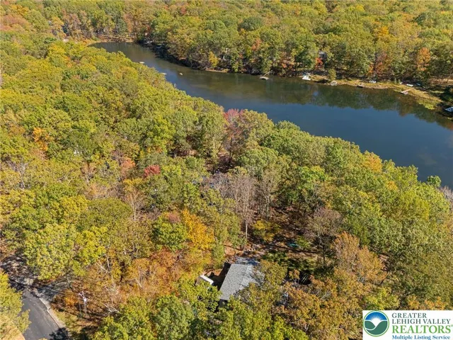 a view of a house with backyard water fountain and sitting area
