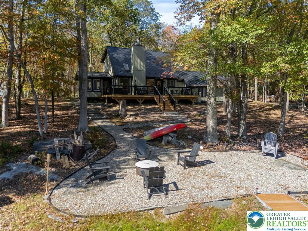 809 Boulder Court North Hawley, PA 18428 - Photo 42 of 43 a view of a house with backyard water fountain and sitting area