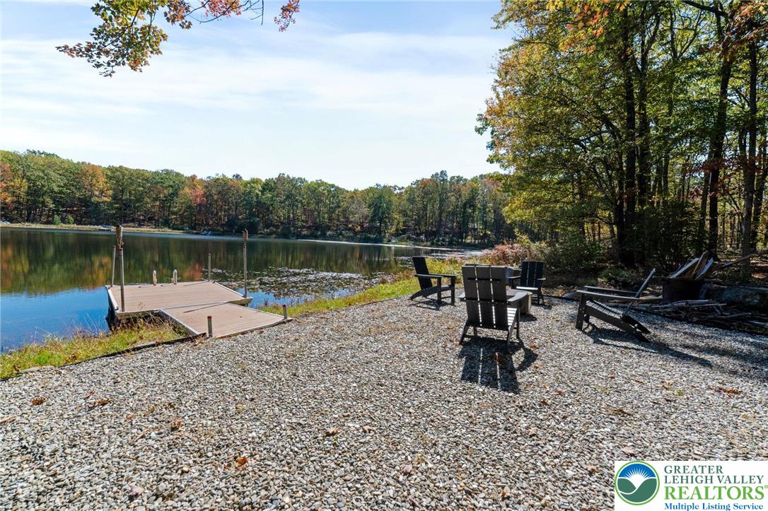 809 Boulder Court North Hawley, PA 18428 - Photo 5 of 43 a view of a lake with a bench and lake view