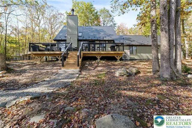 a kitchen with a refrigerator a stove top oven a sink dishwasher and white cabinets with wooden floor