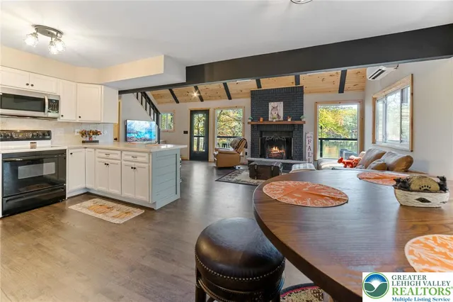 a kitchen with refrigerator cabinets and wooden floor
