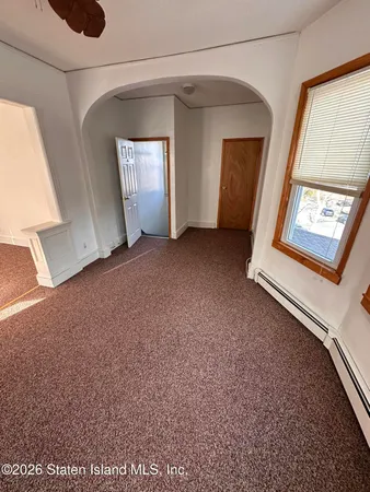 a bedroom with a bed window and couch
