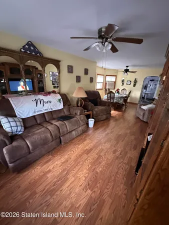 a living room with furniture and a ceiling fan