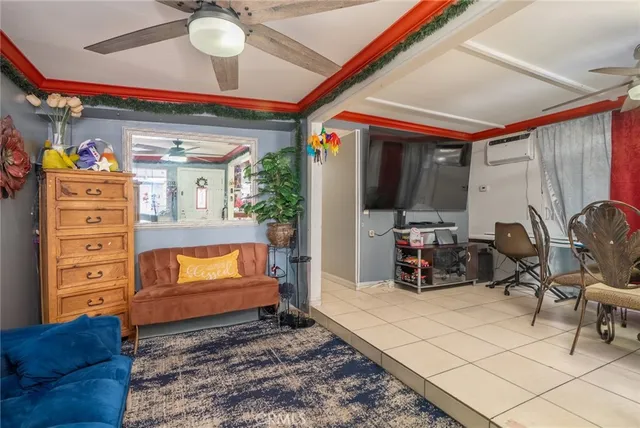a living room with furniture a flat screen tv and gym equipment