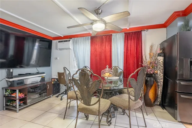 a dining room with furniture and a flat screen tv