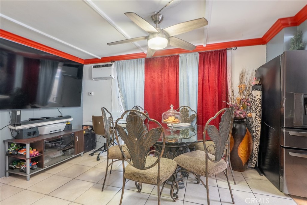 16002 Atlantic Avenue, Unit C11 Compton, CA 90221 - Photo 5 of 19 a dining room with furniture and a flat screen tv