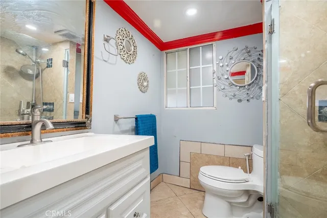 a bathroom with a sink a toilet and shower curtain