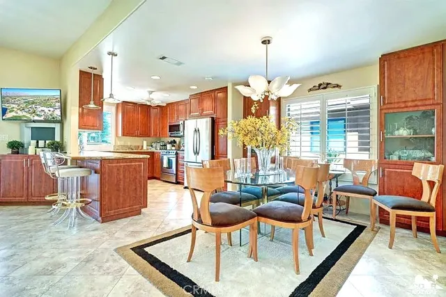 a living room with lots of furniture and a chandelier