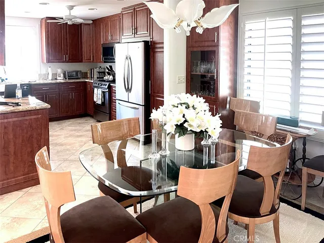 a dining room filled chandelier and kitchen view