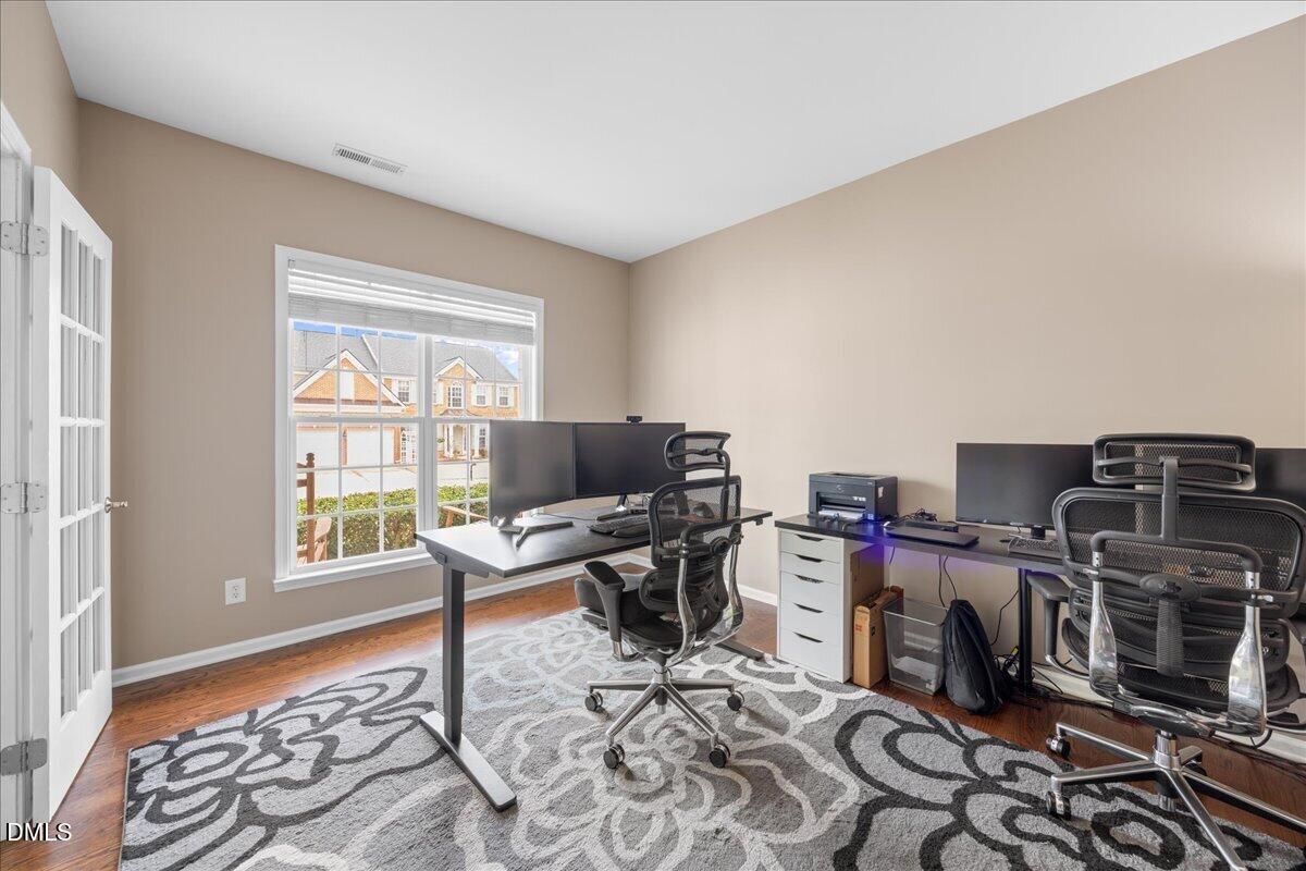 7728 Silver View Lane Raleigh, NC 27613 - Photo 9 of 53 a view of a workspace with furniture and a window