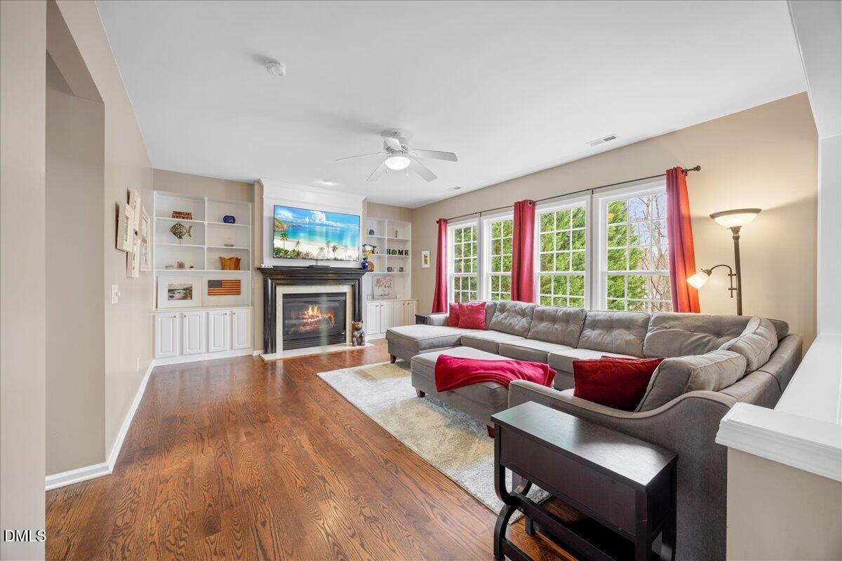 7728 Silver View Lane Raleigh, NC 27613 - Photo 10 of 53 a living room with furniture windows and a fireplace