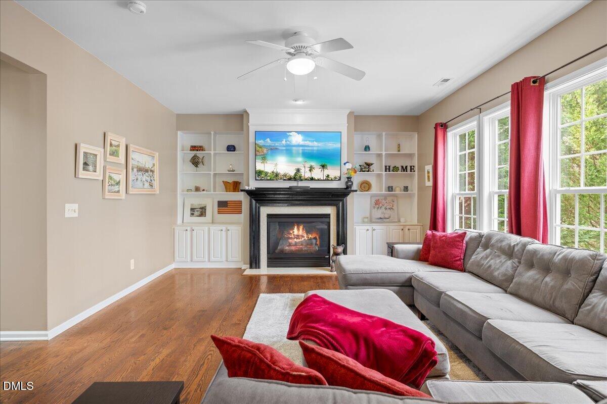 7728 Silver View Lane Raleigh, NC 27613 - Photo 11 of 53 a living room with furniture fireplace and a large window