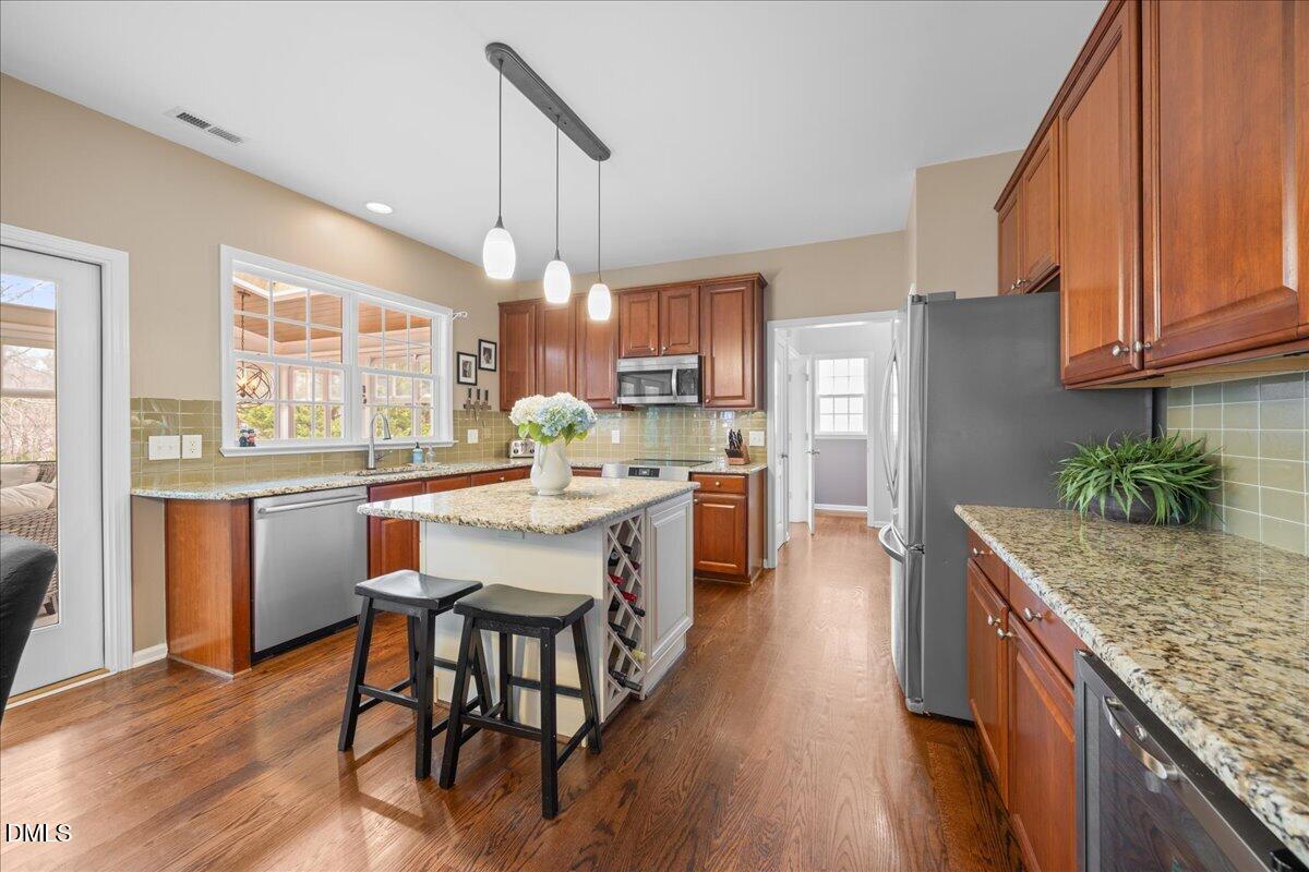 7728 Silver View Lane Raleigh, NC 27613 - Photo 14 of 53 a kitchen with granite countertop counter space a sink appliances and cabinets