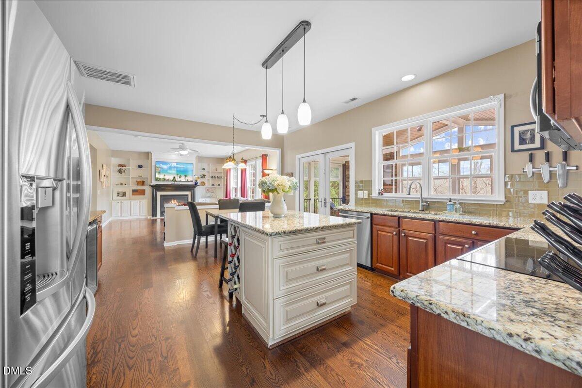 7728 Silver View Lane Raleigh, NC 27613 - Photo 15 of 53 a kitchen with counter top space and painting on the wall