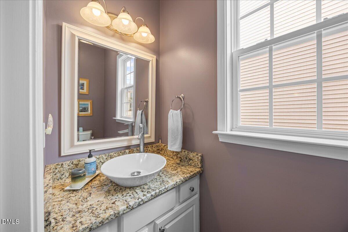 7728 Silver View Lane Raleigh, NC 27613 - Photo 16 of 53 a bathroom with a granite countertop sink and a mirror