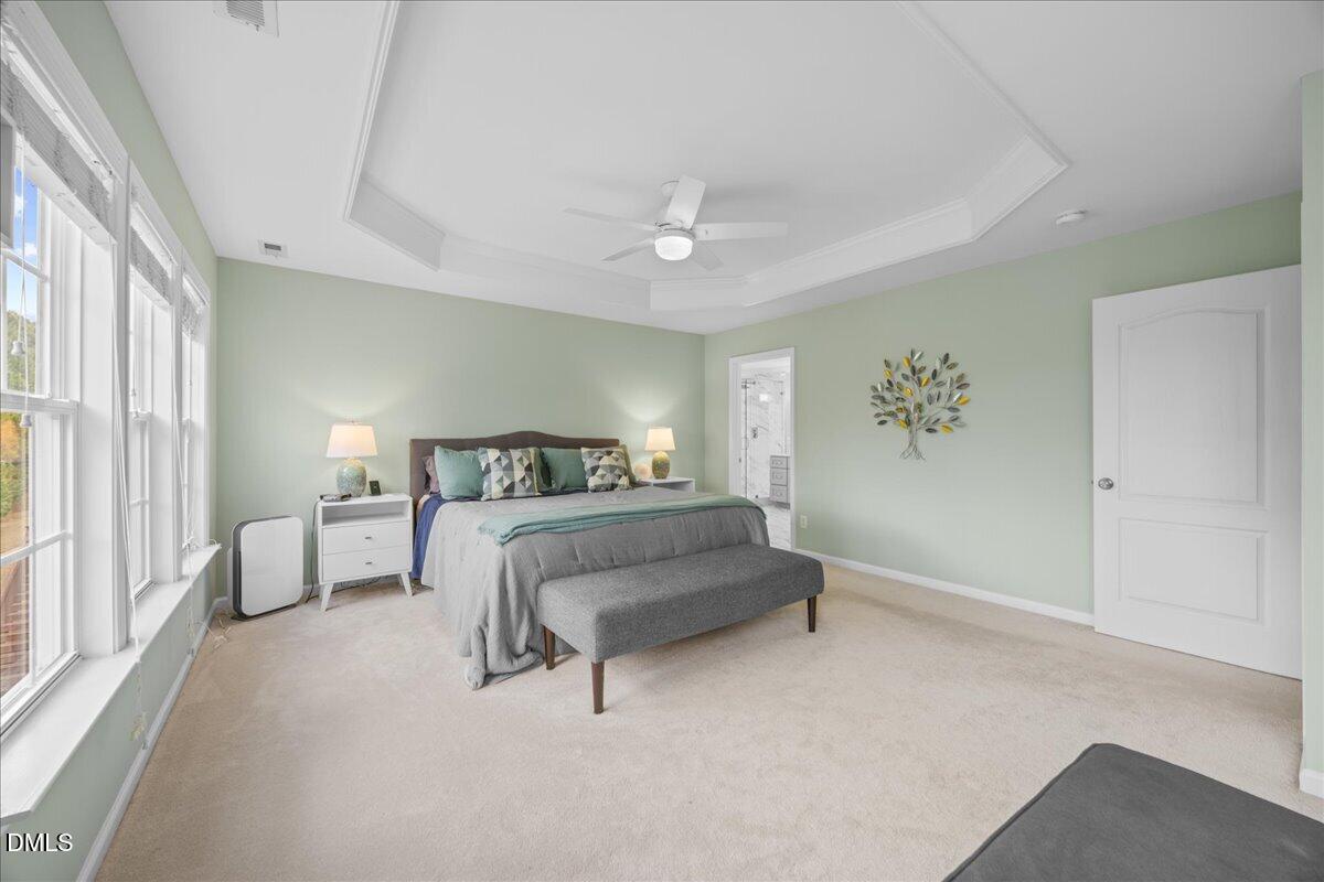 7728 Silver View Lane Raleigh, NC 27613 - Photo 23 of 53 a bedroom with a bed and a chandelier