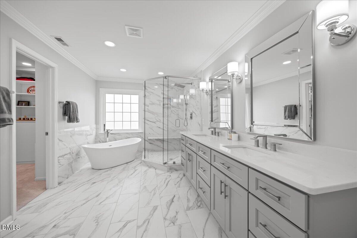 7728 Silver View Lane Raleigh, NC 27613 - Photo 25 of 53 a large bathroom with a large tub and sink