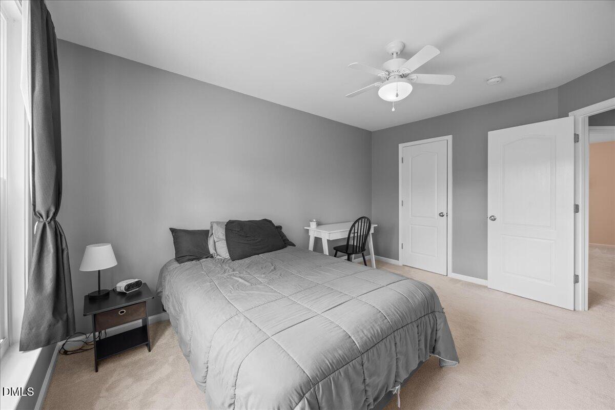 7728 Silver View Lane Raleigh, NC 27613 - Photo 32 of 53 a bedroom with two beds and a chandelier