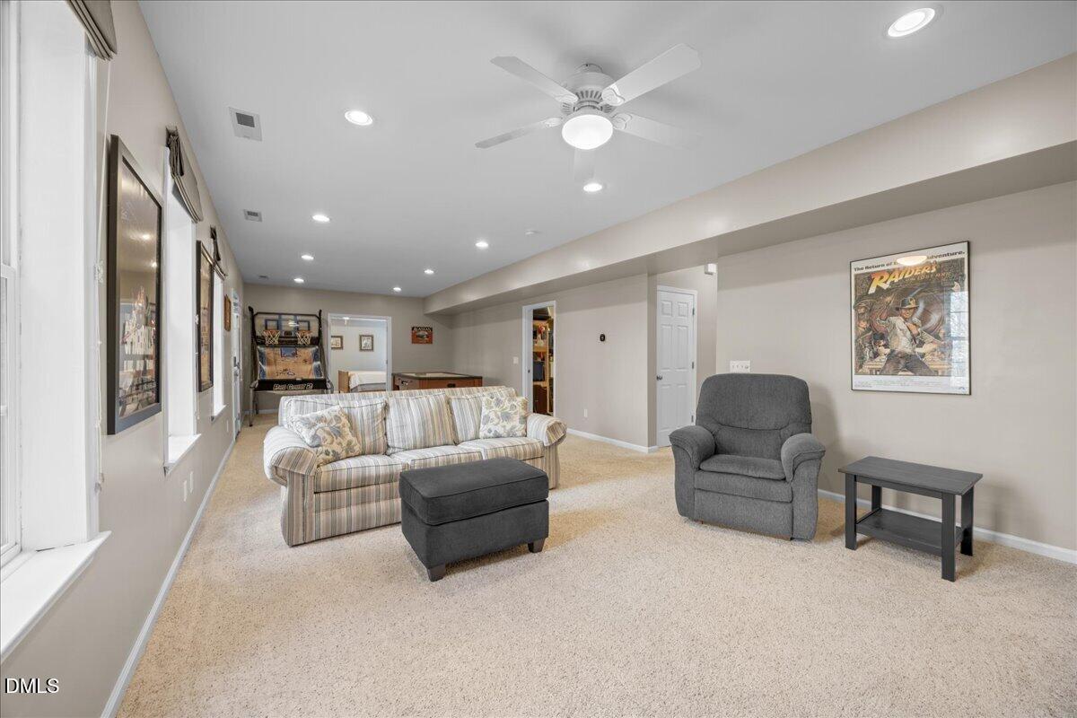 7728 Silver View Lane Raleigh, NC 27613 - Photo 35 of 53 a living room with furniture and a ceiling fan