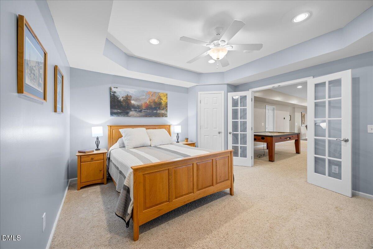 7728 Silver View Lane Raleigh, NC 27613 - Photo 39 of 53 a bed room with a bed and a chandelier