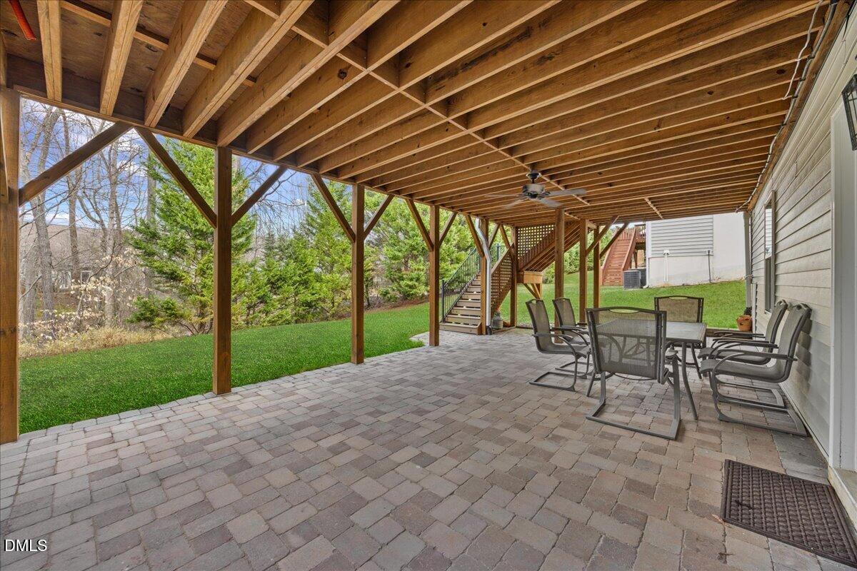 7728 Silver View Lane Raleigh, NC 27613 - Photo 41 of 53 a view of patio with table and chairs under an umbrella with a barbeque grill
