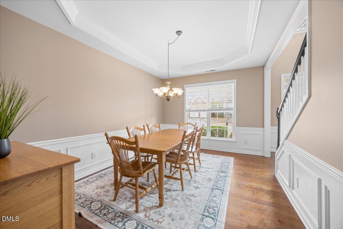 7728 Silver View Lane Raleigh, NC 27613 - Photo 7 of 53 a view of a dining room with furniture window and wooden floor