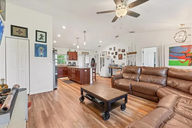 a living room with furniture and a wooden floor