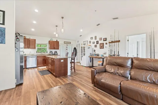 a living room with furniture and kitchen view