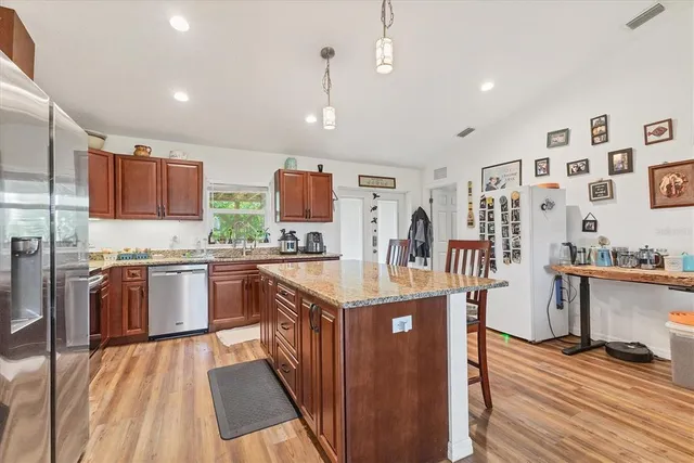 a kitchen with stainless steel appliances granite countertop a stove and a sink