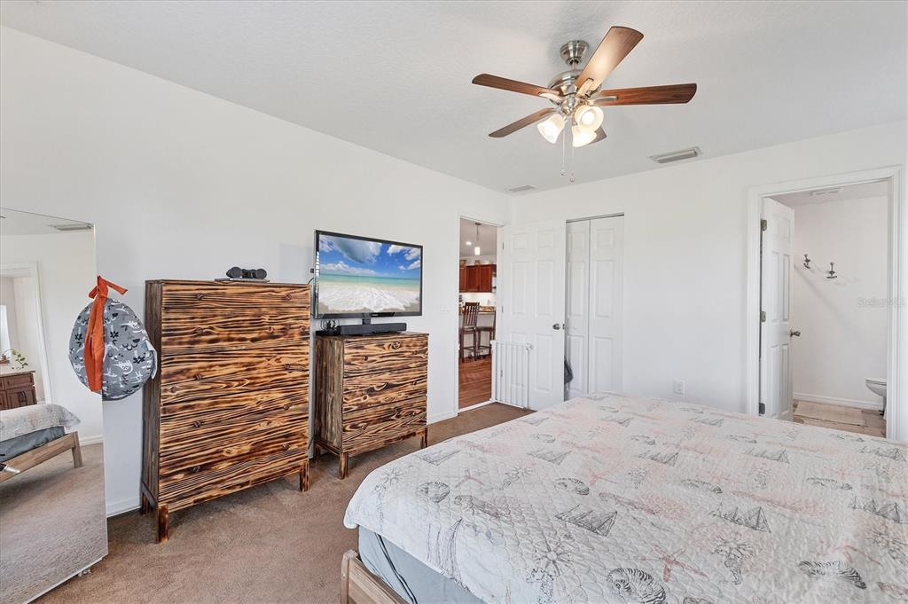 7745 Wauchula Road Myakka City, FL 34251 - Photo 25 of 44 a bed room with a bed and a ceiling fan
