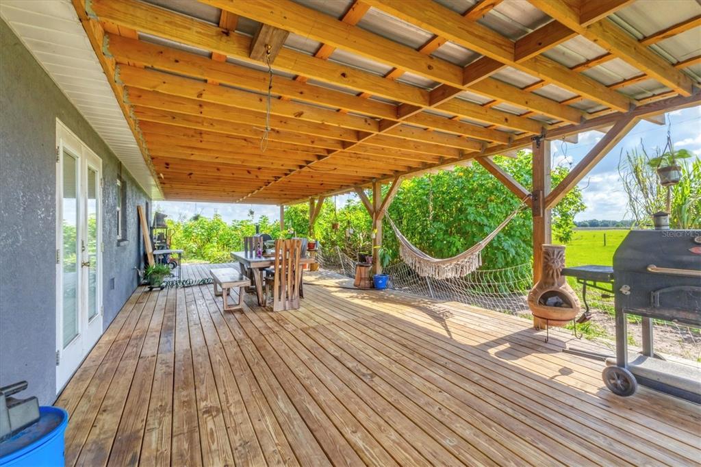 7745 Wauchula Road Myakka City, FL 34251 - Photo 30 of 44 a patio with glass top table and chairs