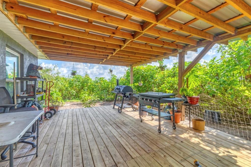 7745 Wauchula Road Myakka City, FL 34251 - Photo 32 of 44 a patio with wooden floors and outdoor seating