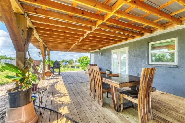 a view of a patio with table and chairs and potted plants