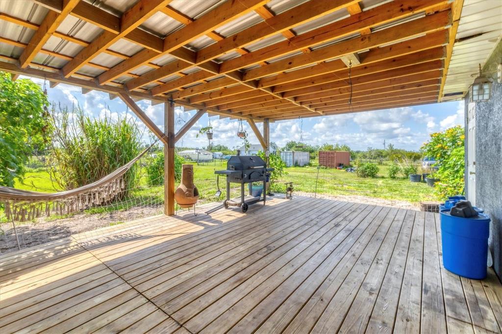 7745 Wauchula Road Myakka City, FL 34251 - Photo 34 of 44 a view of a porch with wooden floor