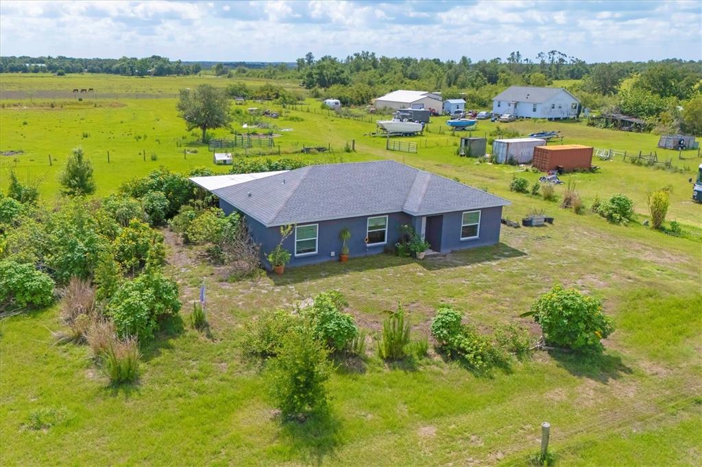 7745 Wauchula Road Myakka City, FL 34251 - Photo 6 of 44 an aerial view of a house with a garden and lake view
