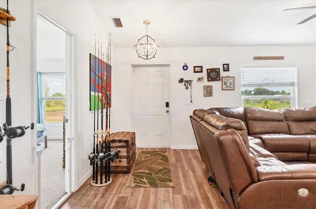 a living room with furniture a flat screen tv and a window