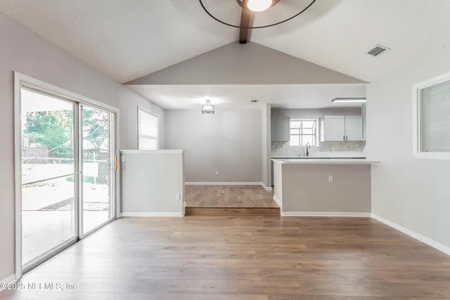 a kitchen with stainless steel appliances a sink stove top oven and refrigerator