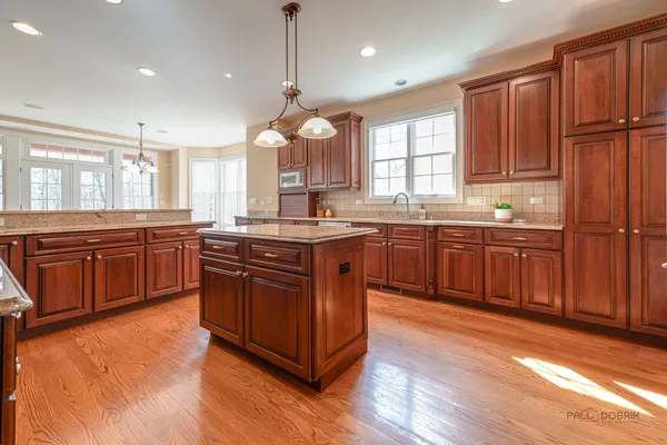 a balcony with wooden floor and trees in the back