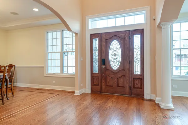 a view of a dining room with furniture chandelier and wooden floor