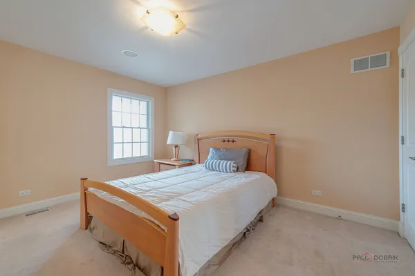 a bed sitting in a room next to a window