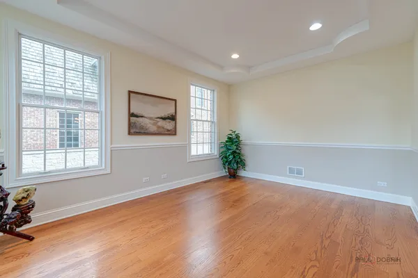 a view of a dining room with furniture a chandelier and wooden floor