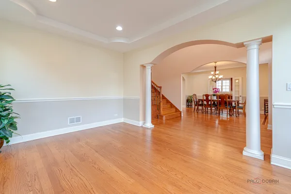 a view of a dining room with furniture wooden floor and chandelier