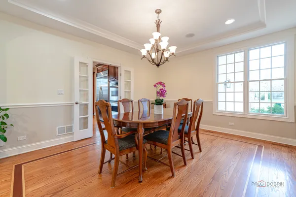 a view of a dining room with furniture wooden floor and chandelier